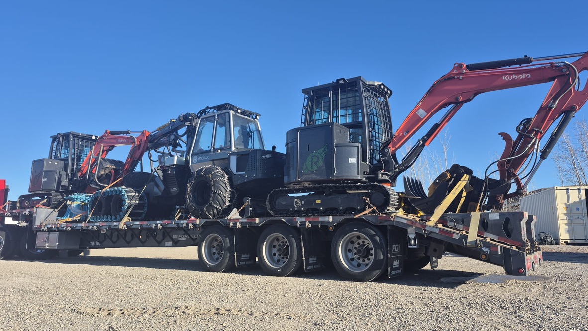 Low-bed trailer loaded with the small-footprint forestry fleet